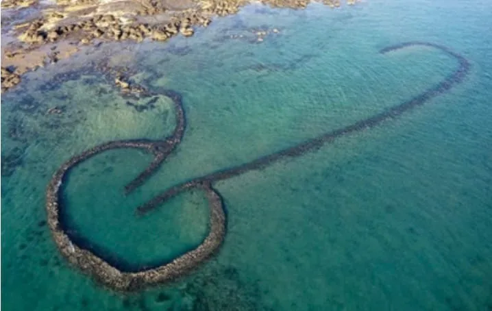Tidal fish trap built from rocks on a beach