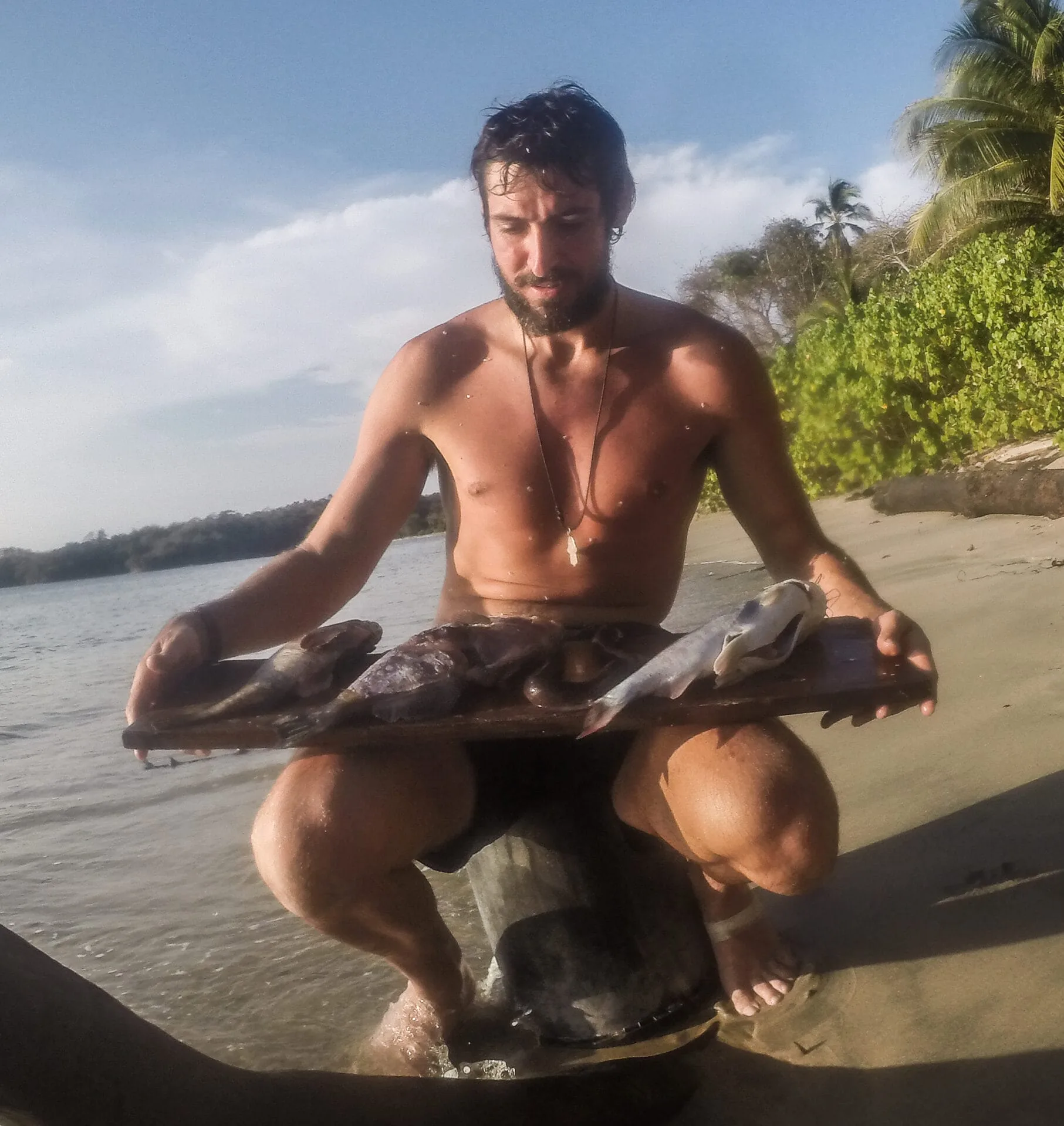 Man with fish on beach