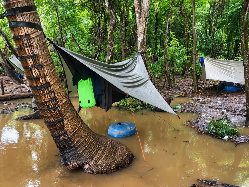 Camp tarp above flooded ground after heavy rain