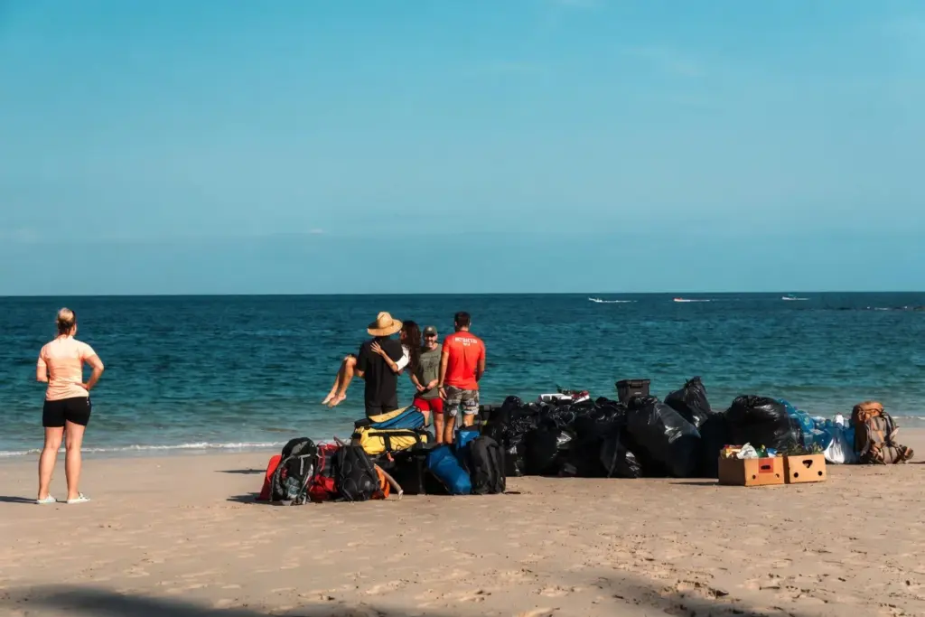 Expedition bags piled on the beach on arrival day