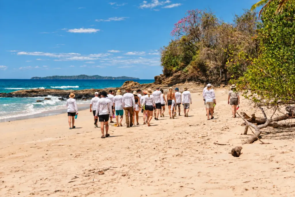 Group of Desert Island Survival participants walking along a wild island beach in Panama