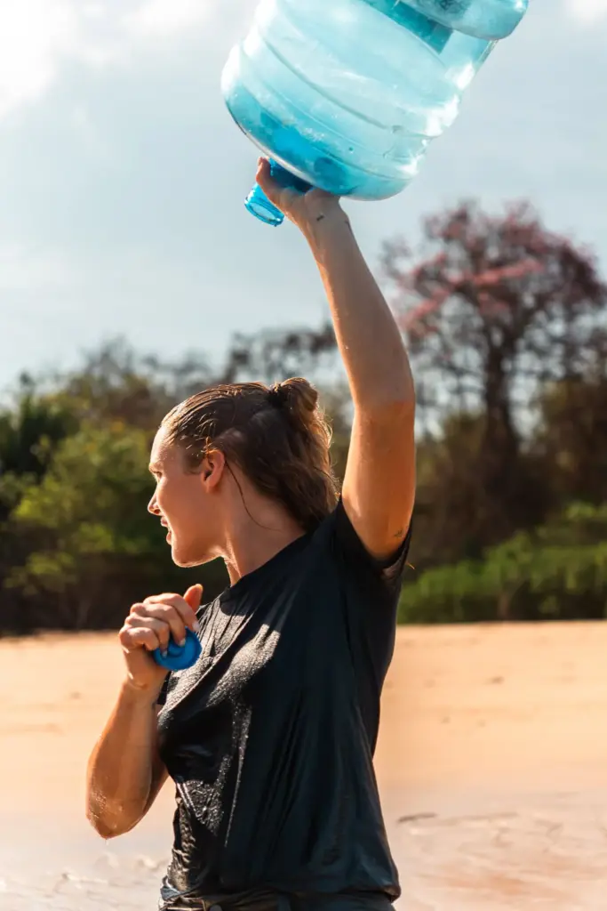 Refillable water bottle on a desert island for survival, staying hydrated and healthy.