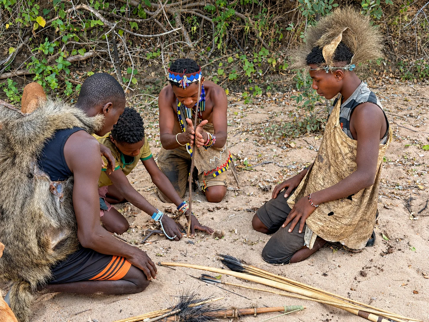men demonstrate traditional fire-starting techniques in Tanzania.