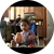 Child pointing at a doll in a high chair
