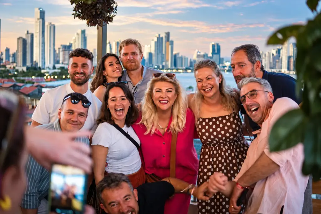 The group celebrates together with the Panama City skyline behind them