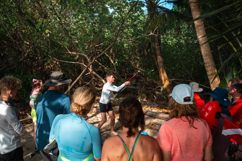 Desert island survival training: instructor demonstrates technique to group.